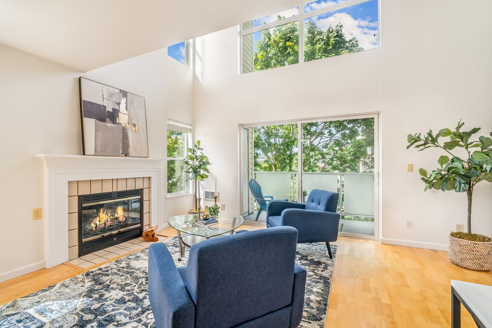 Bright living room with fireplace staged for sale